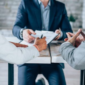 Business meeting with documents and discussions.