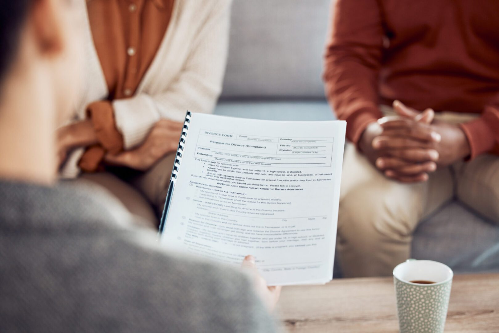 Couple in consultation, reviewing documents and coffee.