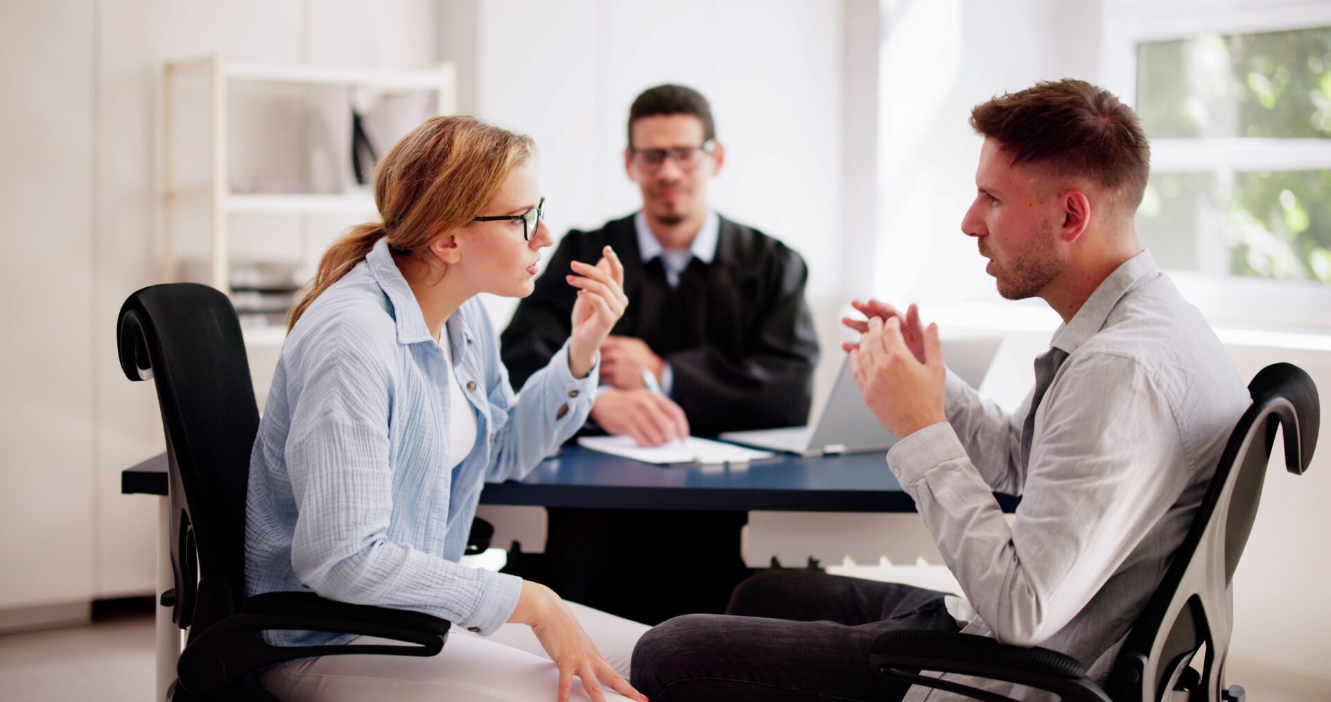 Three people discussing in an office setting.