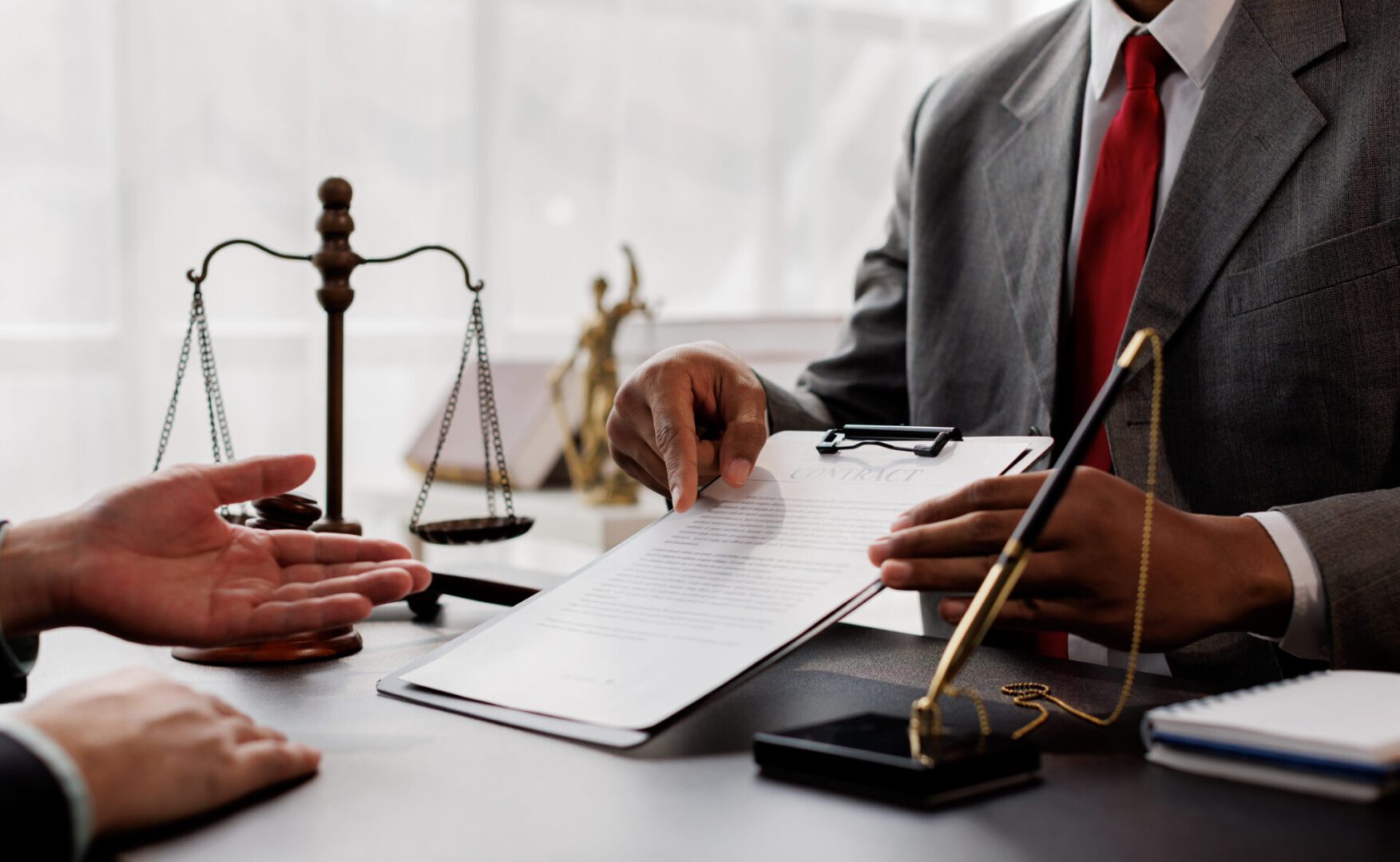 Lawyer discussing document with client.