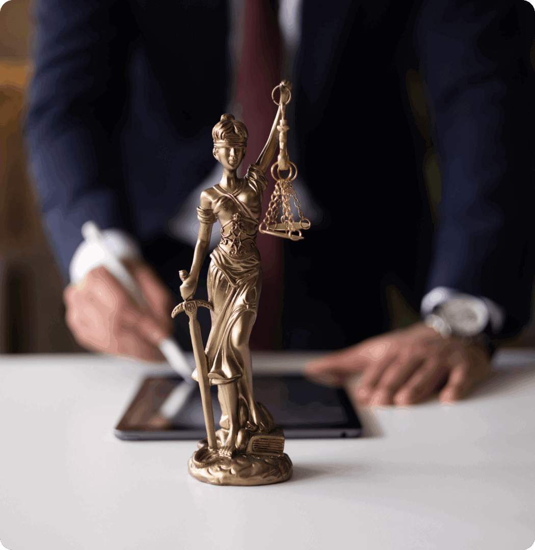 Justice statue with person signing document.