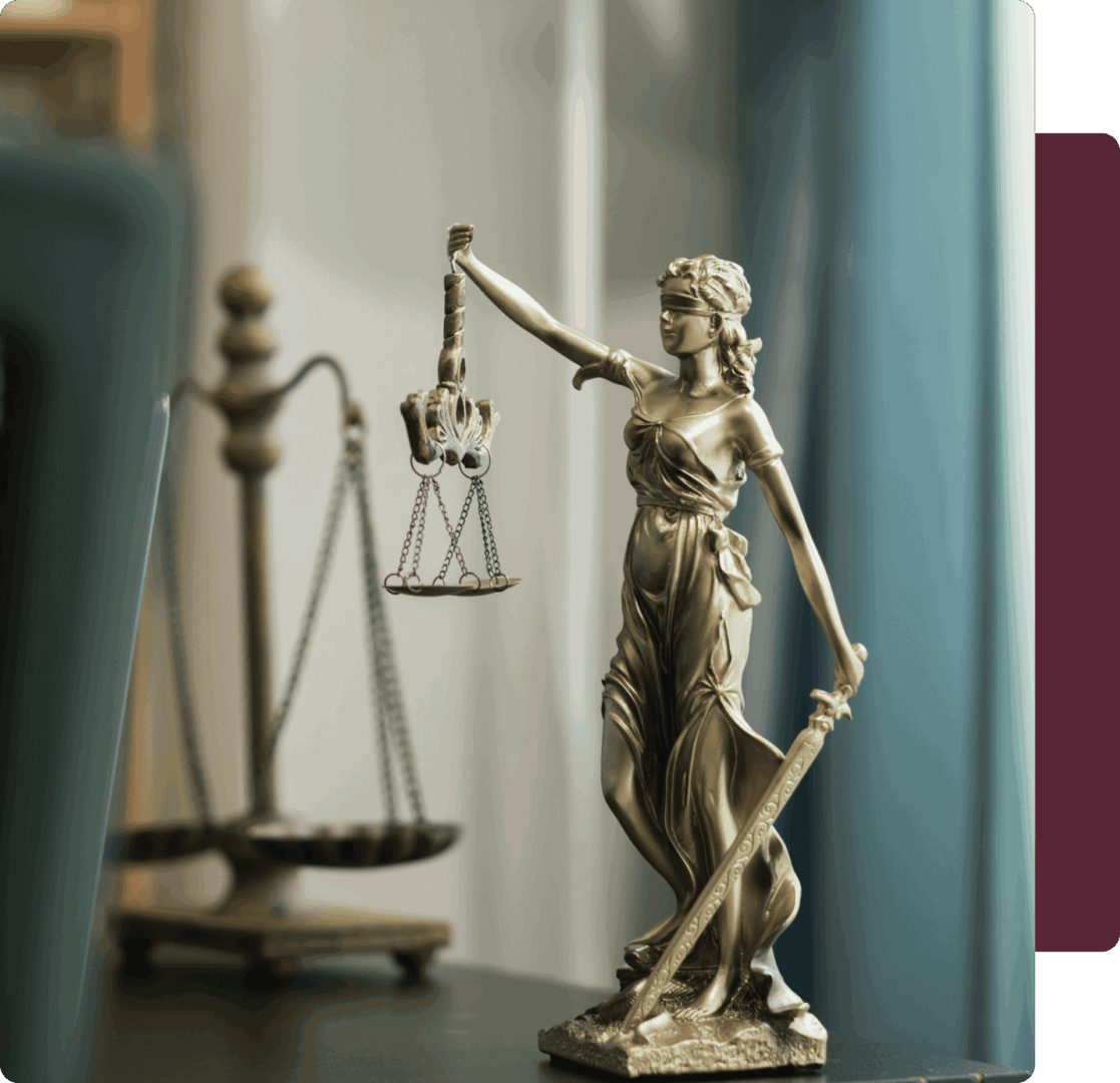 Blindfolded Lady Justice statue with scales.