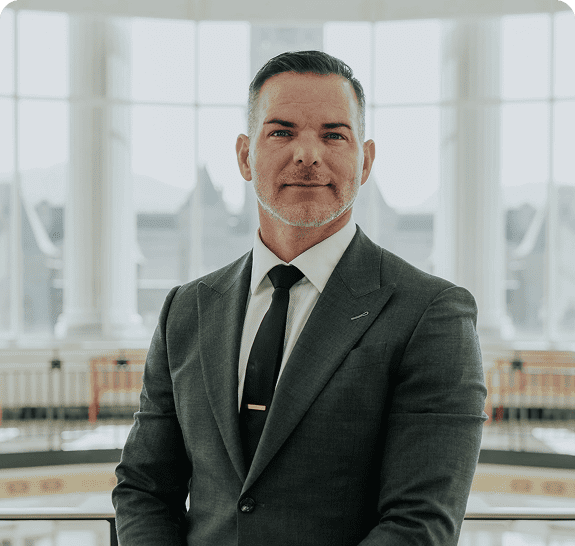 Man in suit standing in elegant interior.
