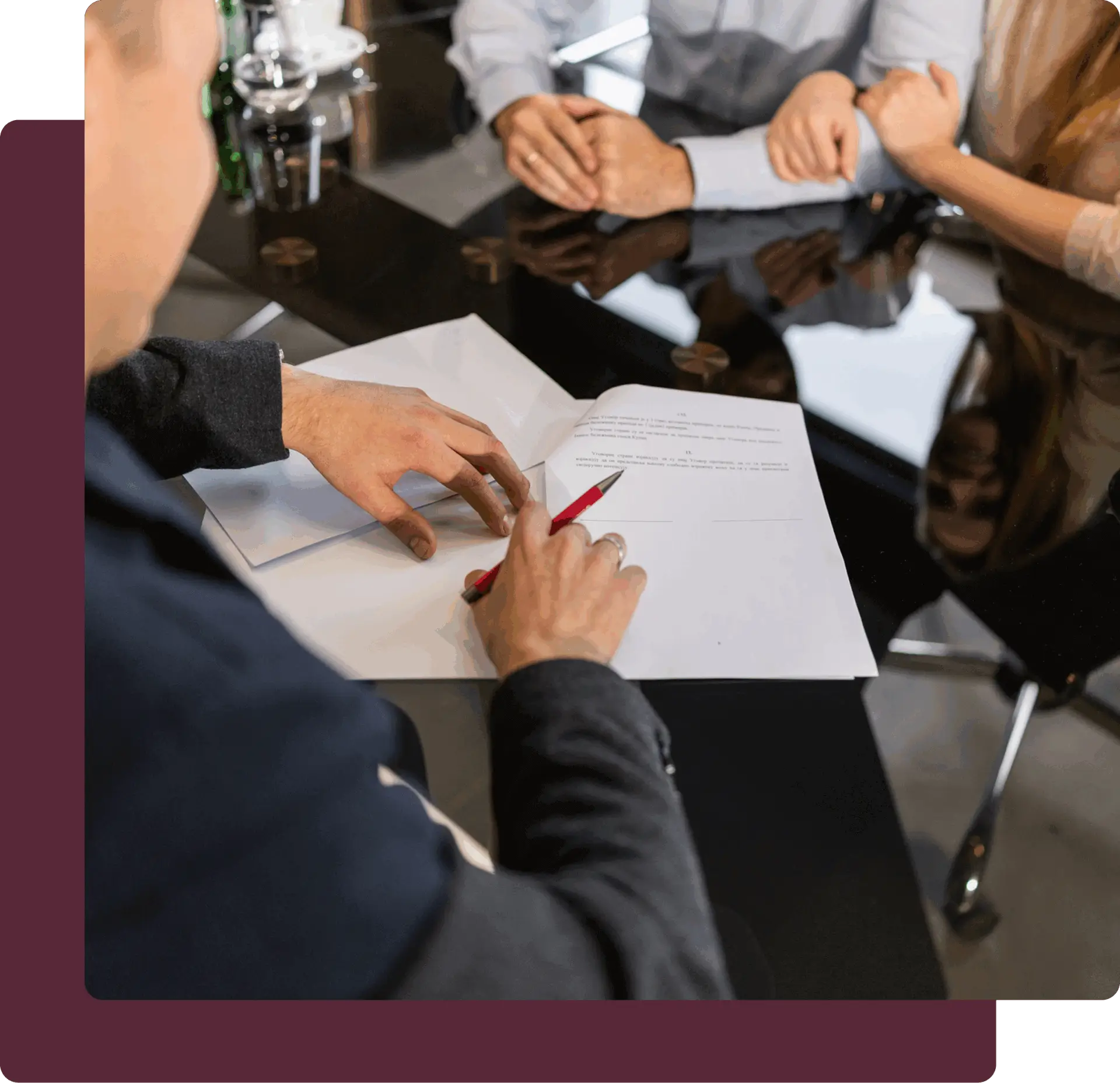 Signing documents at a business meeting table.