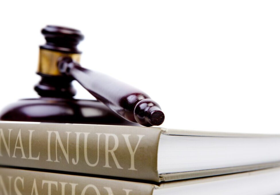 Gavel resting on personal injury book.
