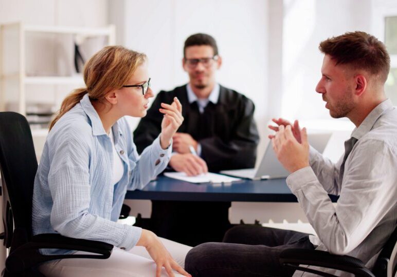Three people discussing in an office setting.