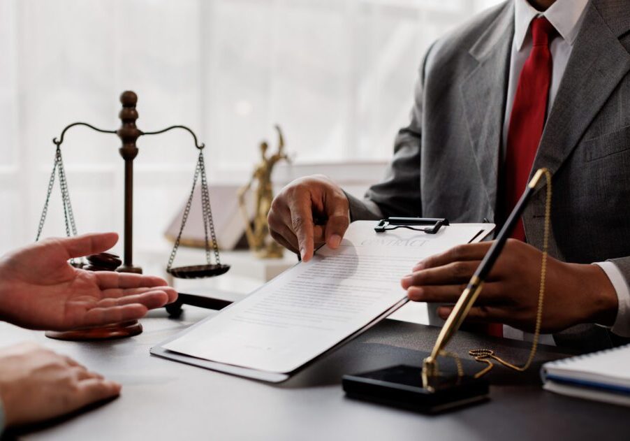 Lawyer discussing document with client.